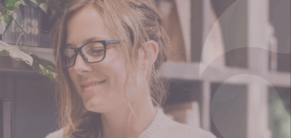 woman smiling while typing on her phone