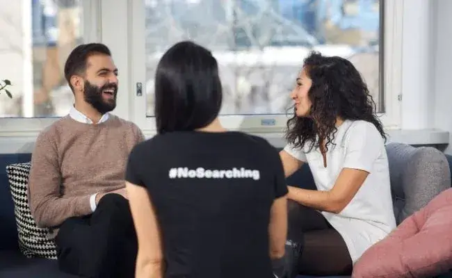 man and women sitting and laughing