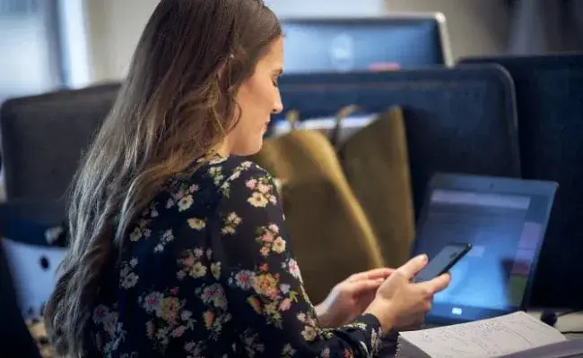 young woman typing on a phone screen