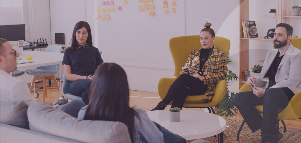 a group of coworkers listening to their colleague presentation