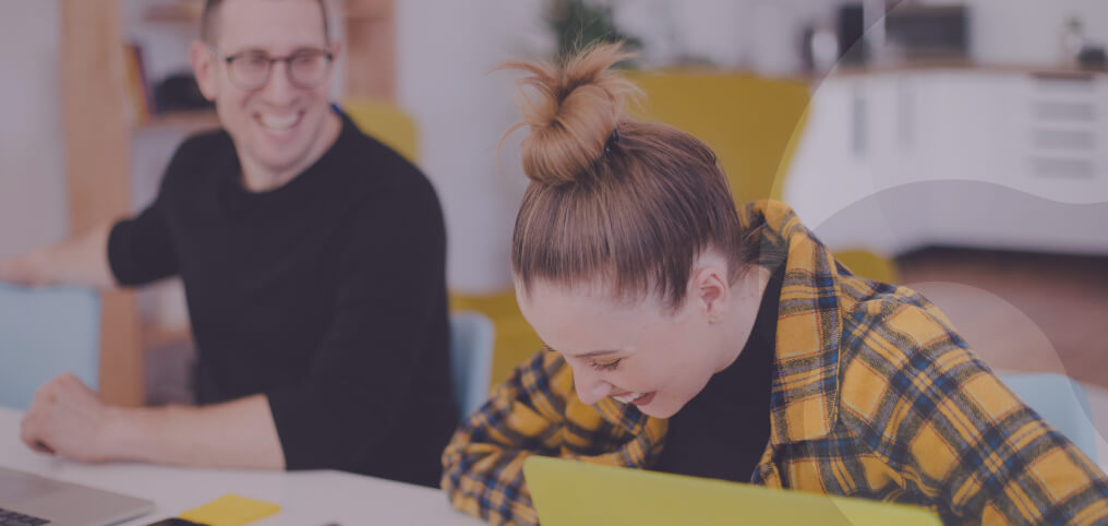 coworkers sitting in office and laughing