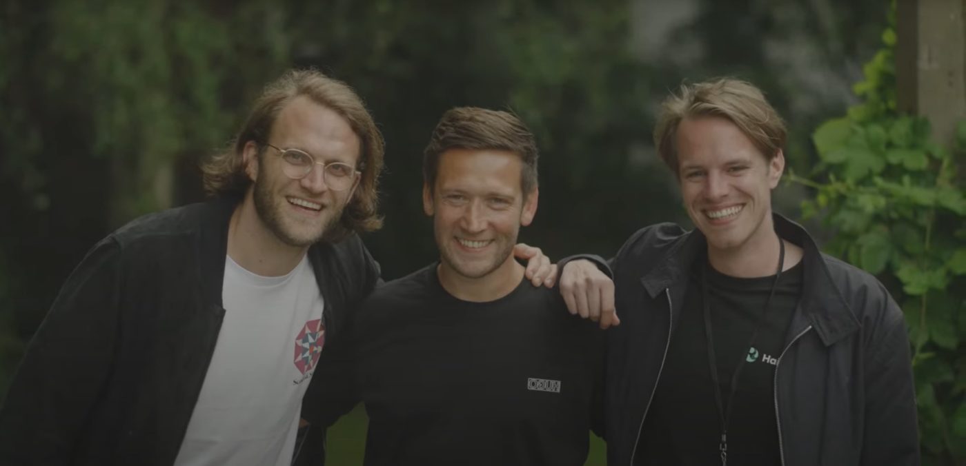 three man standing together and smiling