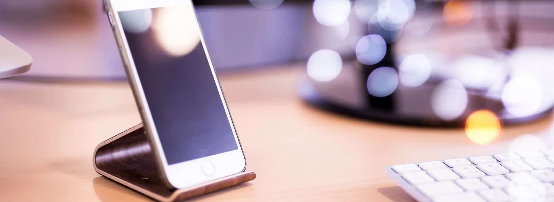 a smartphone on a stand on desk