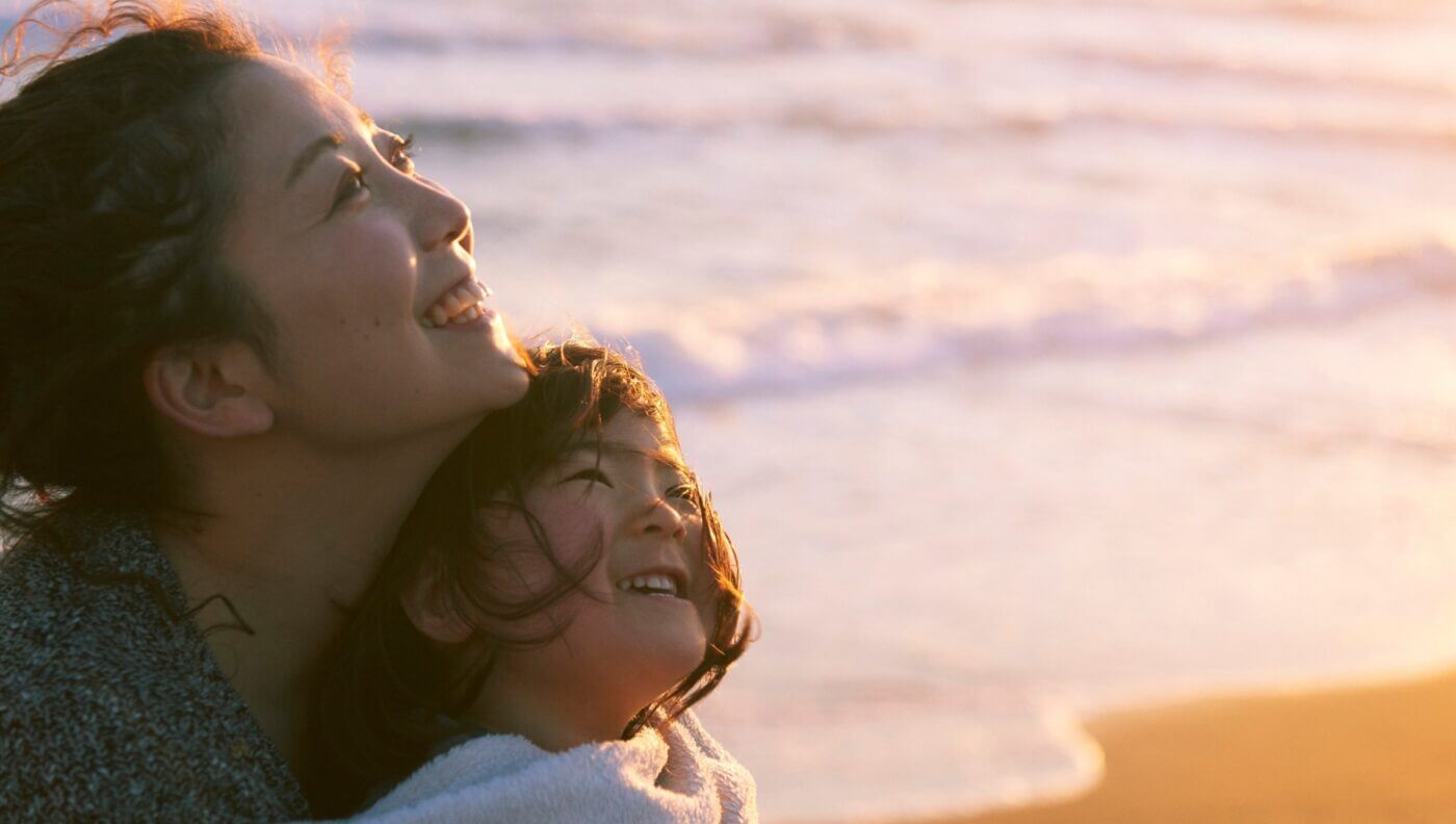 mother and daughter happy at the beach