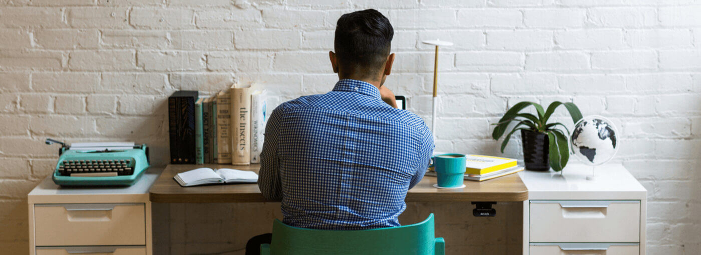 man in a squared shirt working